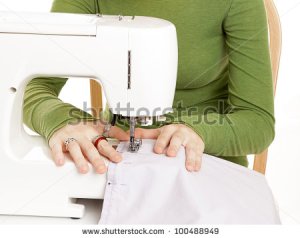 stock-photo-closeup-of-teen-girl-s-hands-using-a-sewing-machine-100488949