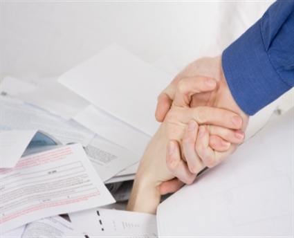 Hands-buried-under-paperwork