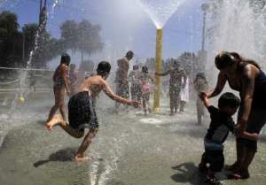 FULLERTON CA, AUGUST 8, 2012: Fullerton locals were cooling off in the Spray Pool at Lemon Park in Fullerton on August 8, 2012 while the temperature was around 95 degrees. A heat wave will maintain its grip over the Southland today, sending valley temperature past the century mark, but the humidity will be lower than forecast, meaning the heat won't be quite as oppressive as had been expected, forecasters said. (Glenn Koenig/ Los Angeles Times)